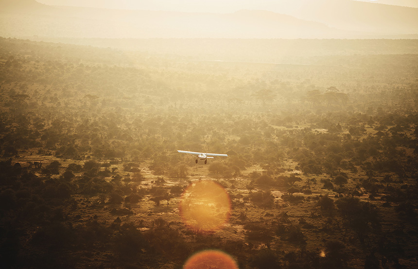 Small plane flying over the savannah, Kenya