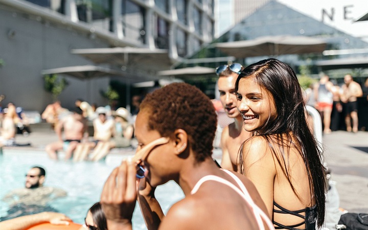 Women beside the pool at the Line Hotel in Los Angeles