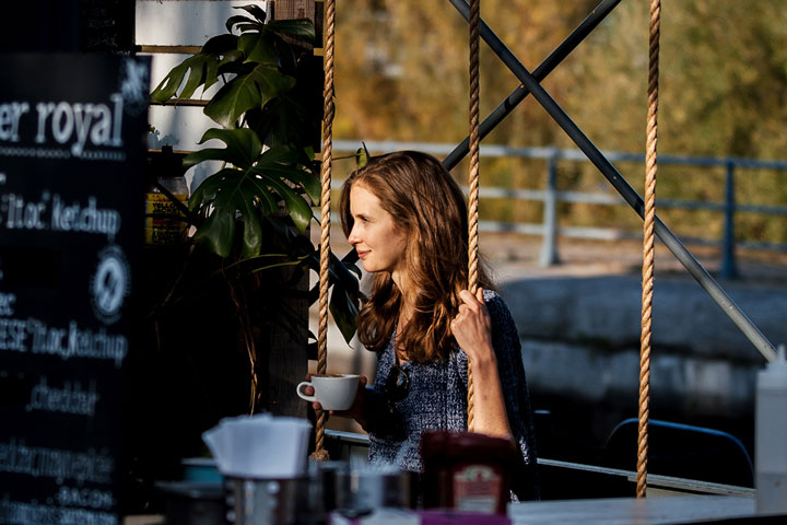 Woman on a swing drinking coffee