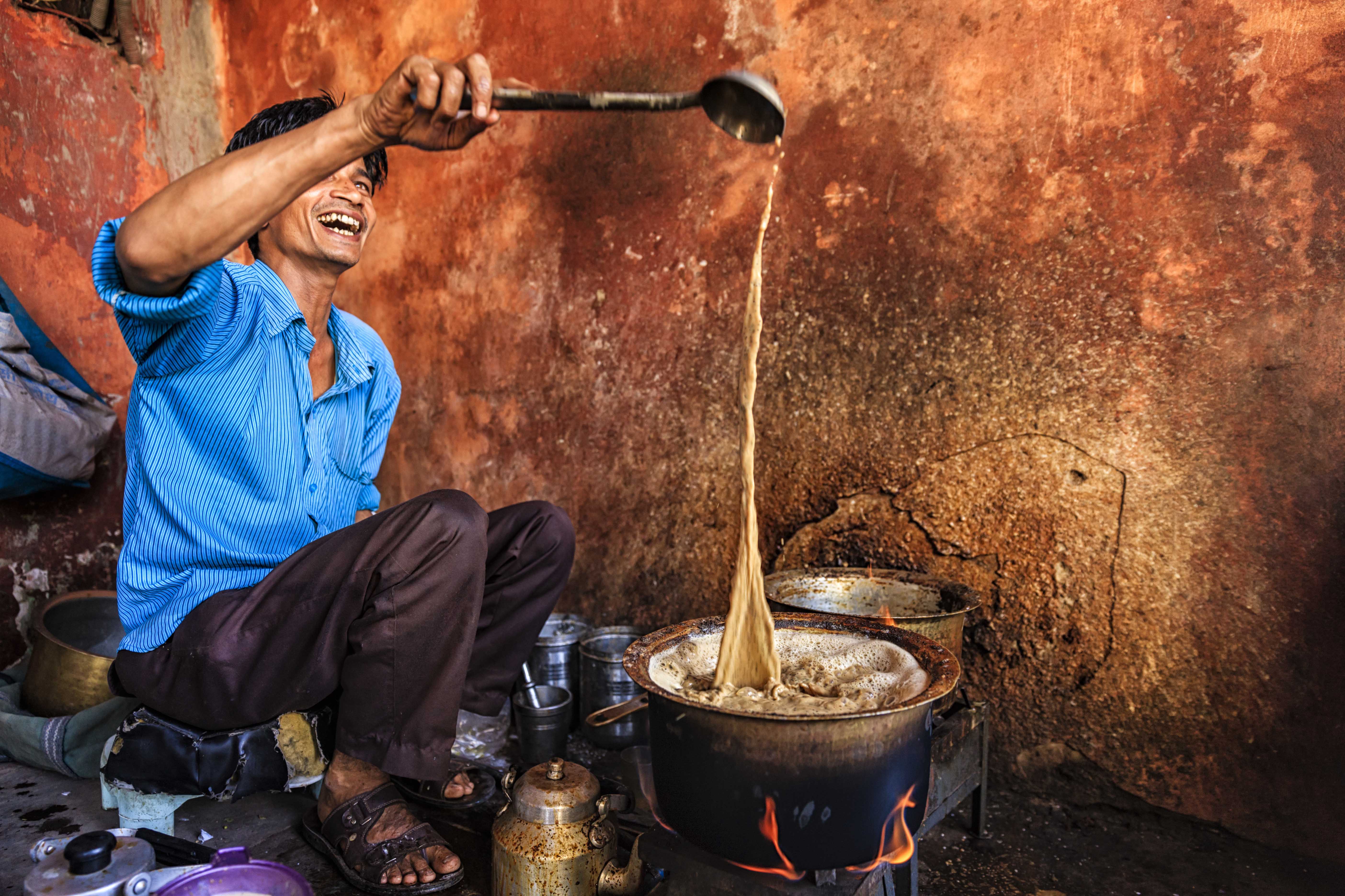 Man pouring chai tea