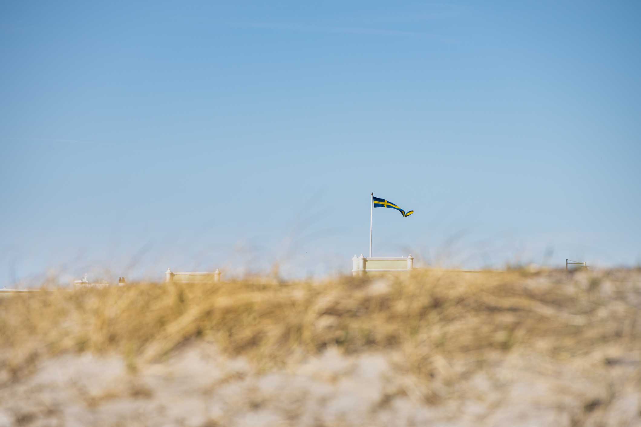 Swedish flag waving on beach