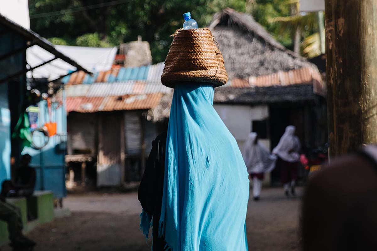 Kenyan lady carring water on head - Kenya